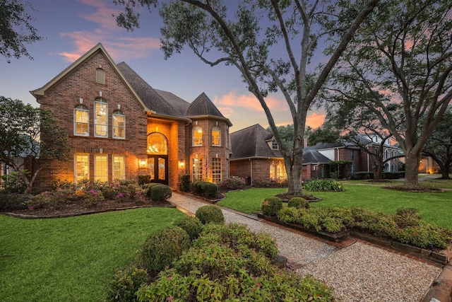 view of front facade with a front lawn and brick siding