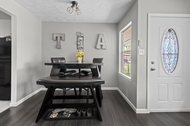 3721 Avalon Ave, Port Arthur, TX 77642 - dining room with dark wood-type flooring, a textured ceiling, and baseboards