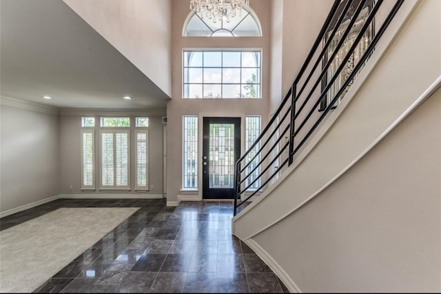 entryway featuring baseboards, a notable chandelier, stairs, and recessed lighting