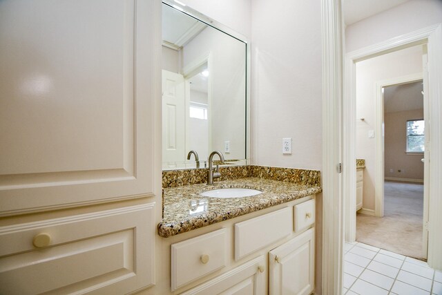 bathroom with tile patterned flooring and vanity
