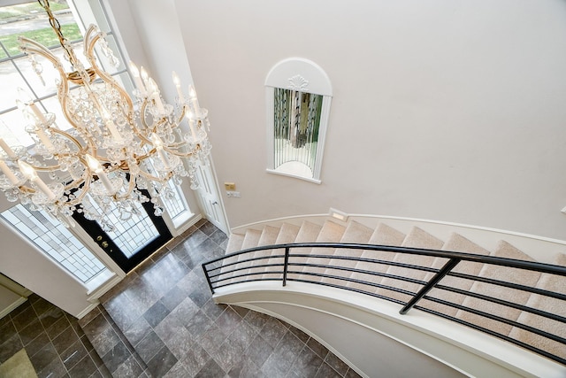 foyer with an inviting chandelier and a healthy amount of sunlight
