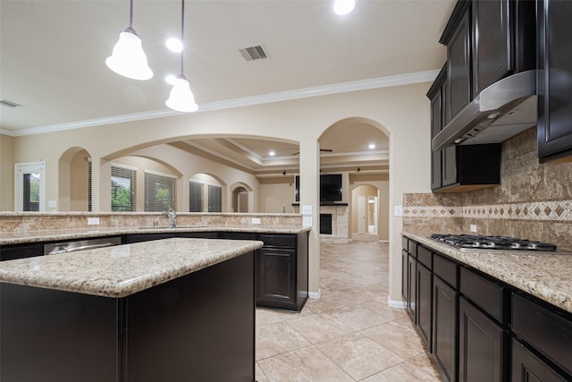 20306 Jade Park Dr, Richmond, TX 77407 - kitchen with stainless steel appliances, extractor fan, visible vents, a sink, and arched walkways