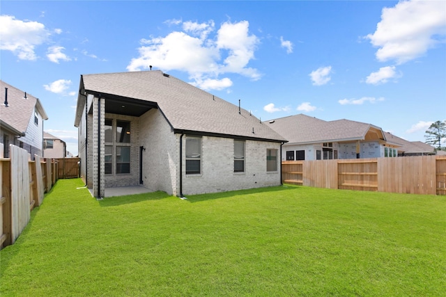 3220 Bello Green Ln, Katy, TX 77493 - back of property featuring brick siding, a patio area, and a shingled roof