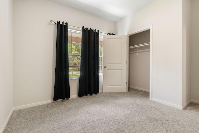 unfurnished bedroom featuring a closet, carpet flooring, and baseboards