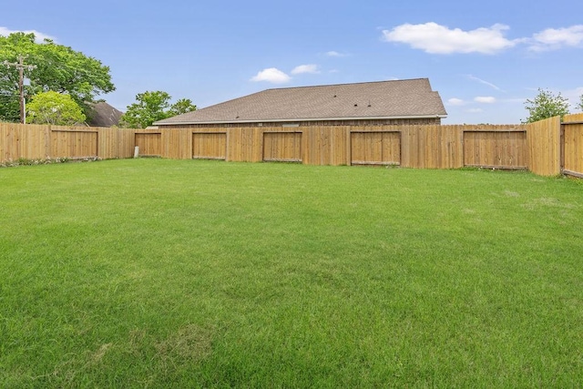 view of yard with a fenced backyard