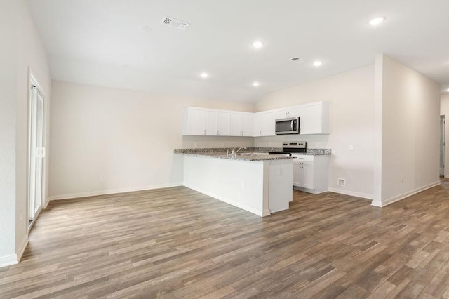 kitchen featuring white cabinets, light wood-style floors, and appliances with stainless steel finishes