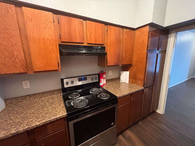 9809 Richmond Ave Unit F10, Houston, TX 77042 - kitchen featuring stainless steel range with electric cooktop, brown cabinets, under cabinet range hood, and dark wood-type flooring