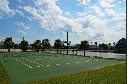 4215 San Jacinto Dr, Galveston, TX 77554 - view of tennis court with a water view