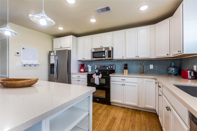4215 San Jacinto Dr, Galveston, TX 77554 - kitchen with stainless steel appliances, backsplash, white cabinetry, pendant lighting, and recessed lighting