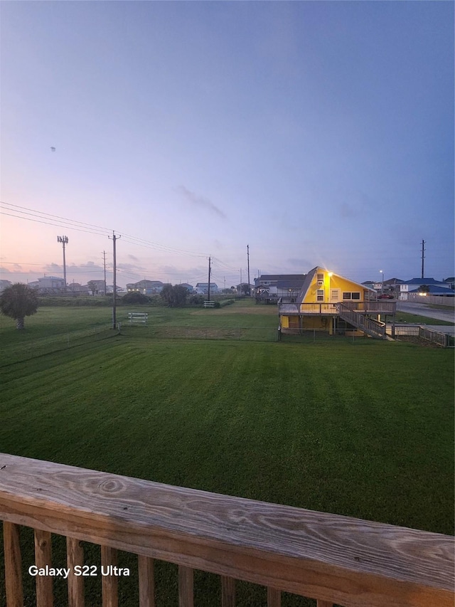 4215 San Jacinto Dr, Galveston, TX 77554 - view of green lawn featuring stairway and a deck
