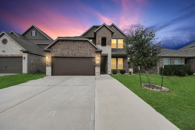 view of front of property featuring concrete driveway, brick siding, a front yard, and a garage