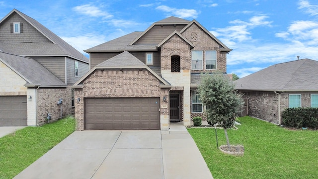 view of front facade with brick siding, driveway, and a front yard