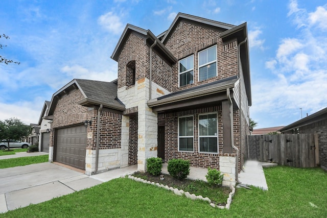 view of front facade with a front lawn, driveway, stone siding, fence, and brick siding