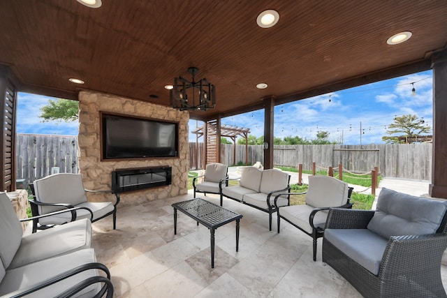 view of patio featuring an outdoor living space with a fireplace and a fenced backyard