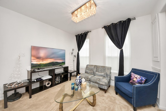living area with an inviting chandelier and carpet floors