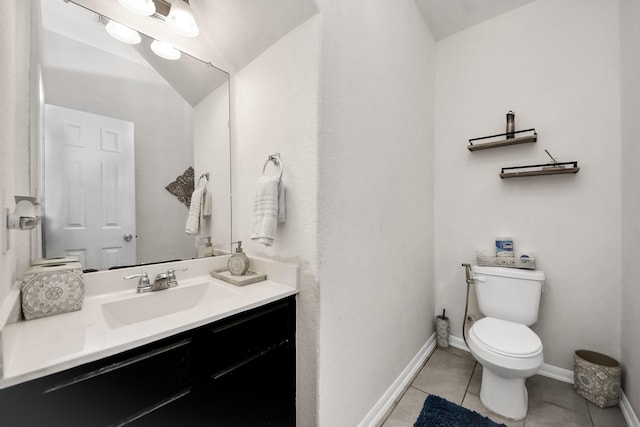 half bathroom with vanity, toilet, tile patterned flooring, and baseboards