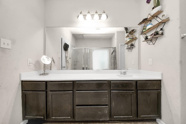 bathroom with baseboards, vanity, and a stall shower