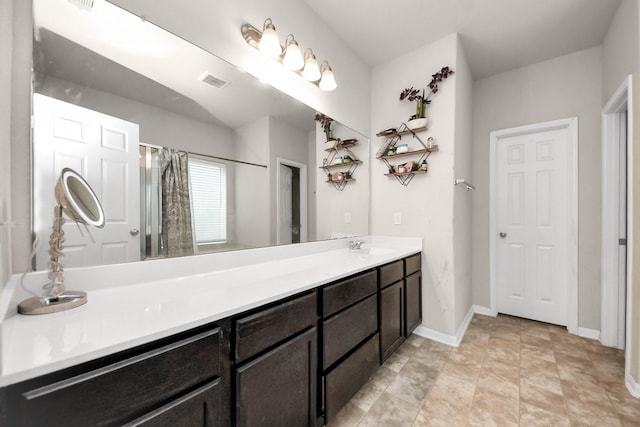 full bathroom with baseboards, visible vents, vanity, and a stall shower