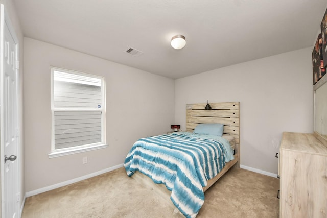 bedroom with baseboards, visible vents, and carpet