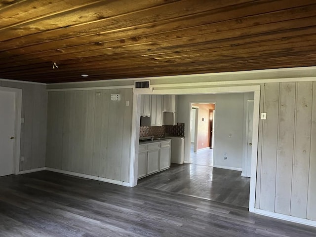 749 Lorrain St, Angleton, TX 77515 - unfurnished living room with wood ceiling, dark wood-style flooring, baseboards, visible vents, and wooden walls
