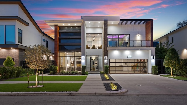 2703 Westgrove Ln, Houston, TX 77027 - contemporary house with an attached garage, driveway, a balcony, and stucco siding