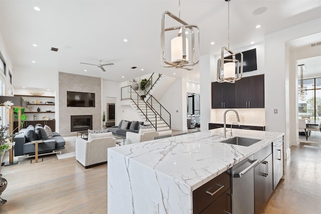 2703 Westgrove Ln, Houston, TX 77027 - kitchen featuring pendant lighting, light wood-style floors, a sink, and recessed lighting