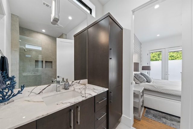 2703 Westgrove Ln, Houston, TX 77027 - ensuite bathroom with wood finished floors, vanity, ensuite bath, visible vents, and recessed lighting