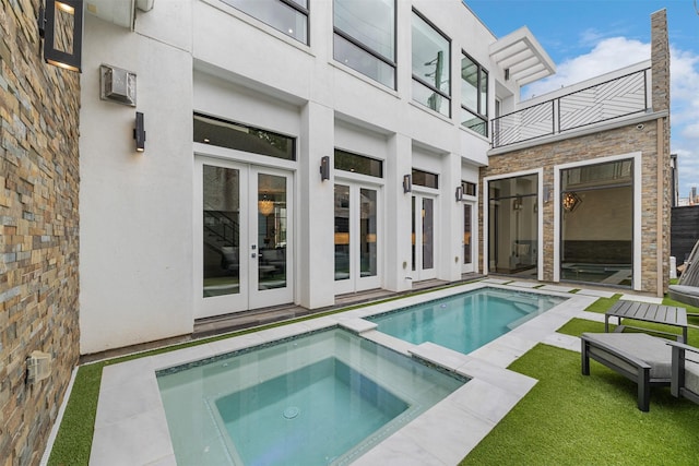 2703 Westgrove Ln, Houston, TX 77027 - view of swimming pool featuring a pool with connected hot tub and french doors
