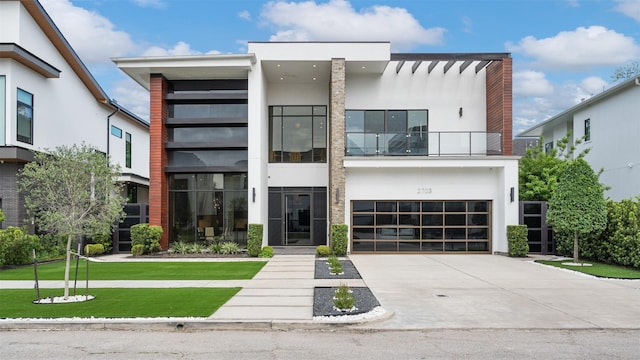 2703 Westgrove Ln, Houston, TX 77027 - modern home with a front lawn, concrete driveway, an attached garage, a balcony, and stucco siding