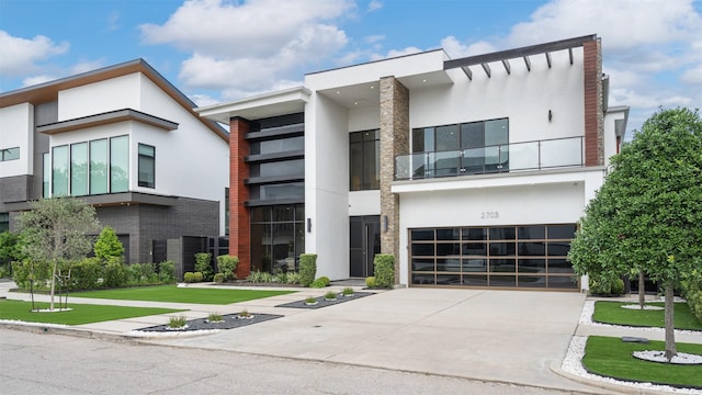 2703 Westgrove Ln, Houston, TX 77027 - modern home featuring an attached garage, concrete driveway, and stucco siding