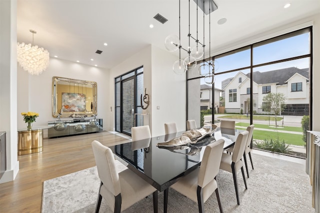 2703 Westgrove Ln, Houston, TX 77027 - dining room with recessed lighting, light wood-type flooring, visible vents, and a notable chandelier