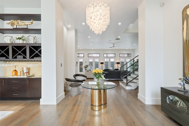 2703 Westgrove Ln, Houston, TX 77027 - interior space with light wood finished floors, a ceiling fan, baseboards, and stairs