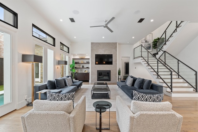 2703 Westgrove Ln, Houston, TX 77027 - living area with stairway, visible vents, a ceiling fan, and wood finished floors
