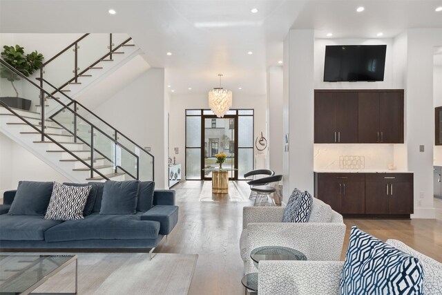 2703 Westgrove Ln, Houston, TX 77027 - living room featuring light wood-style flooring, recessed lighting, and stairway