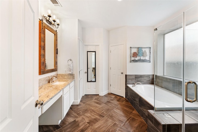 full bathroom featuring an enclosed shower, visible vents, vanity, baseboards, and a garden tub