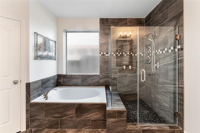 bathroom with a garden tub and a shower stall