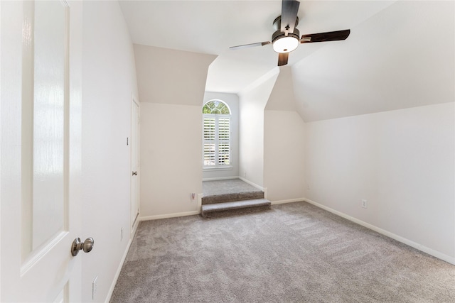 additional living space with carpet floors, lofted ceiling, baseboards, and ceiling fan