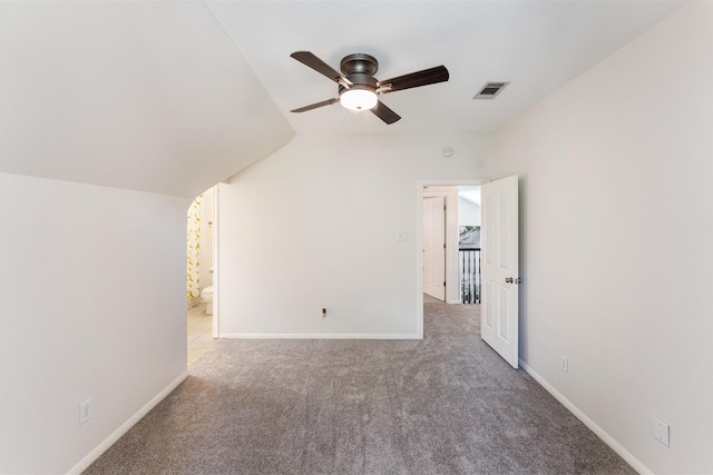 additional living space featuring light carpet, baseboards, visible vents, lofted ceiling, and ceiling fan