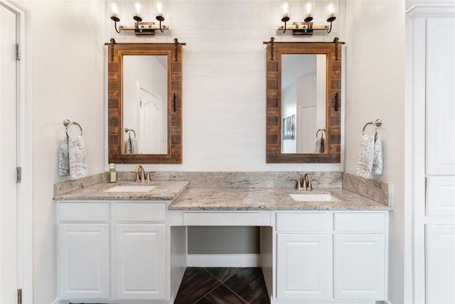 full bath featuring double vanity and a sink