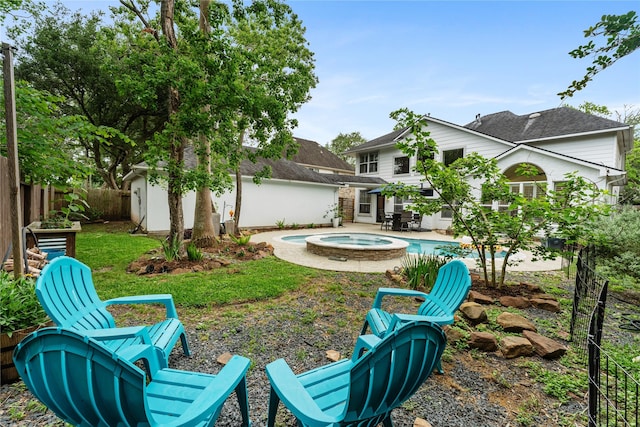 view of yard with an outbuilding, a fenced backyard, an outdoor pool, an in ground hot tub, and a patio