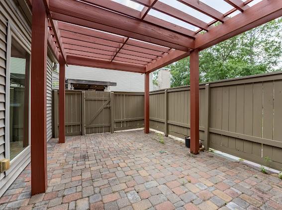 view of patio featuring a pergola, a gate, and a fenced backyard