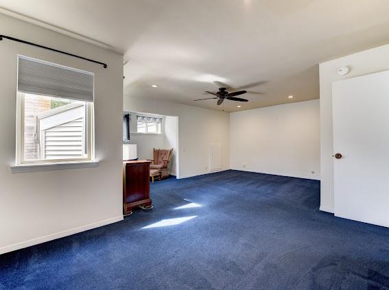 unfurnished living room featuring carpet floors, recessed lighting, ceiling fan, and baseboards