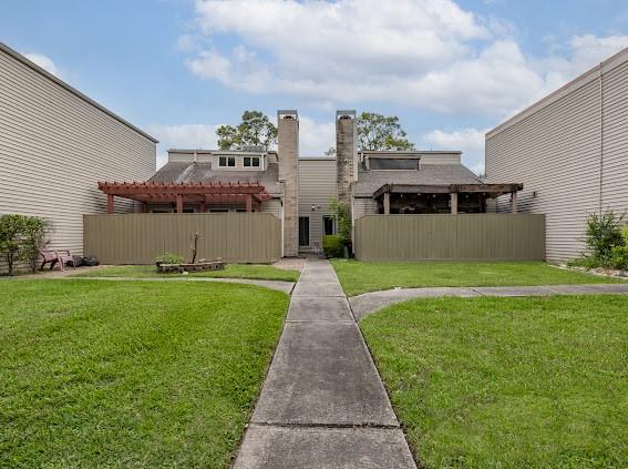 exterior space featuring a pergola and a yard