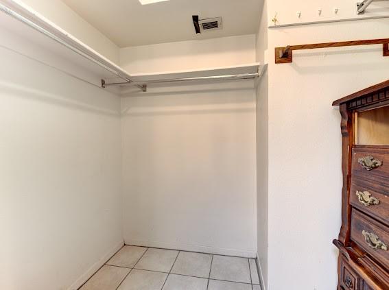 walk in closet featuring light tile patterned flooring and visible vents