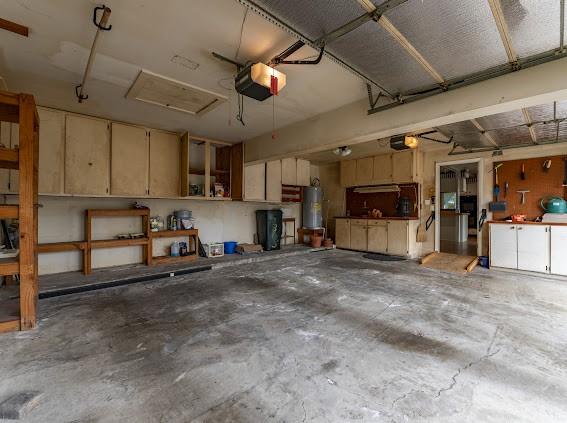garage with a garage door opener and water heater