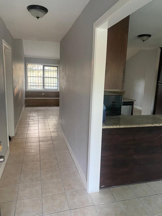 14418 Alkay St, Houston, TX 77045 - hallway with light tile patterned floors and baseboards