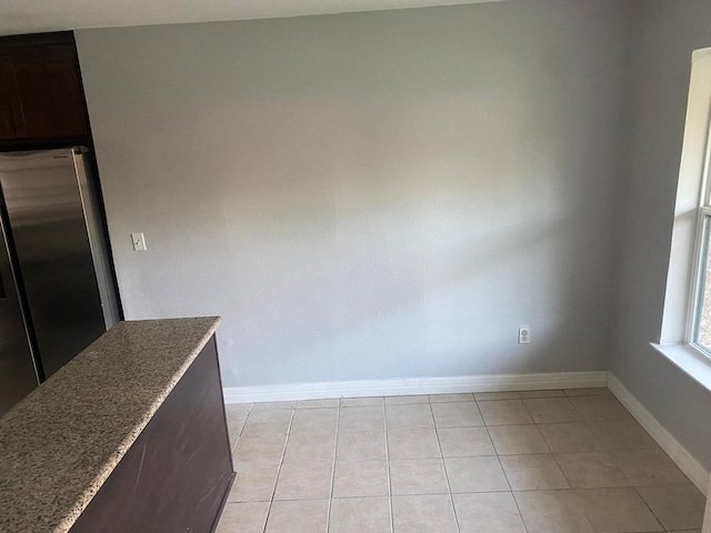 14418 Alkay St, Houston, TX 77045 - unfurnished dining area featuring light tile patterned flooring and baseboards