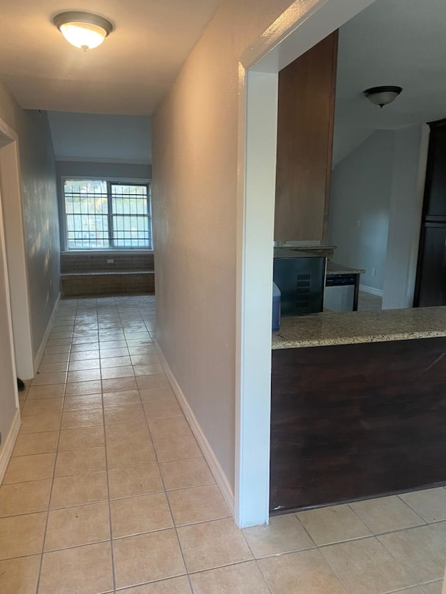 14418 Alkay St, Houston, TX 77045 - hall featuring light tile patterned flooring and baseboards