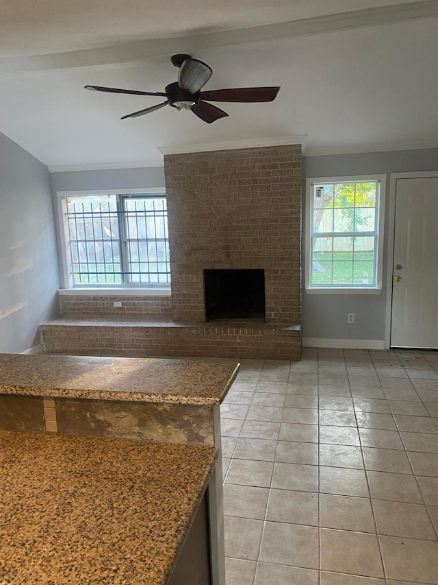 14418 Alkay St, Houston, TX 77045 - unfurnished living room featuring light tile patterned floors, crown molding, a ceiling fan, and a fireplace