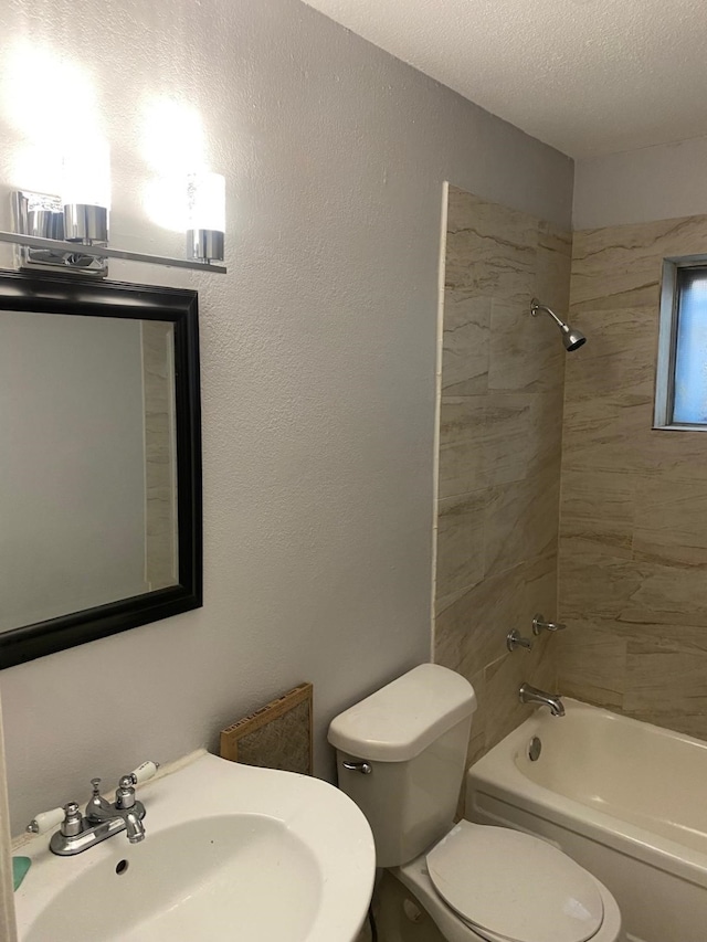 14418 Alkay St, Houston, TX 77045 - bathroom featuring toilet, shower / tub combination, a sink, and a textured ceiling